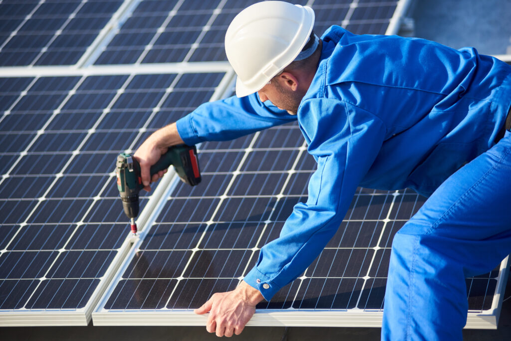 Agent qualifié avec habilitation électrique photovoltaïque installant des panneaux solaires